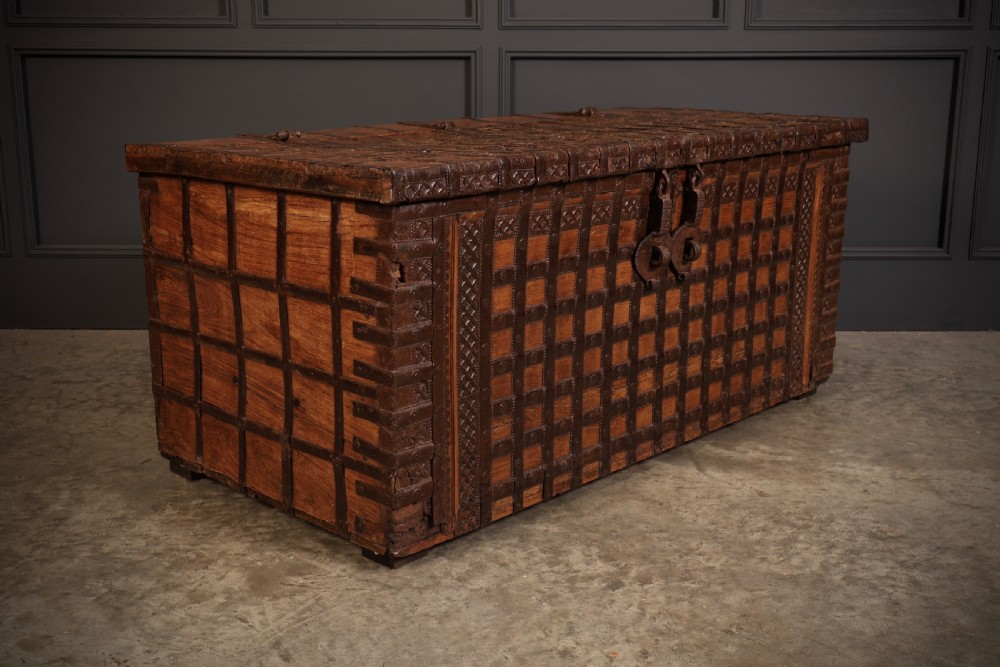 A large rectangular brown hardwood trunk reinforced with a grid of iron straps and featuring heavy iron latches on the front. View VIII
