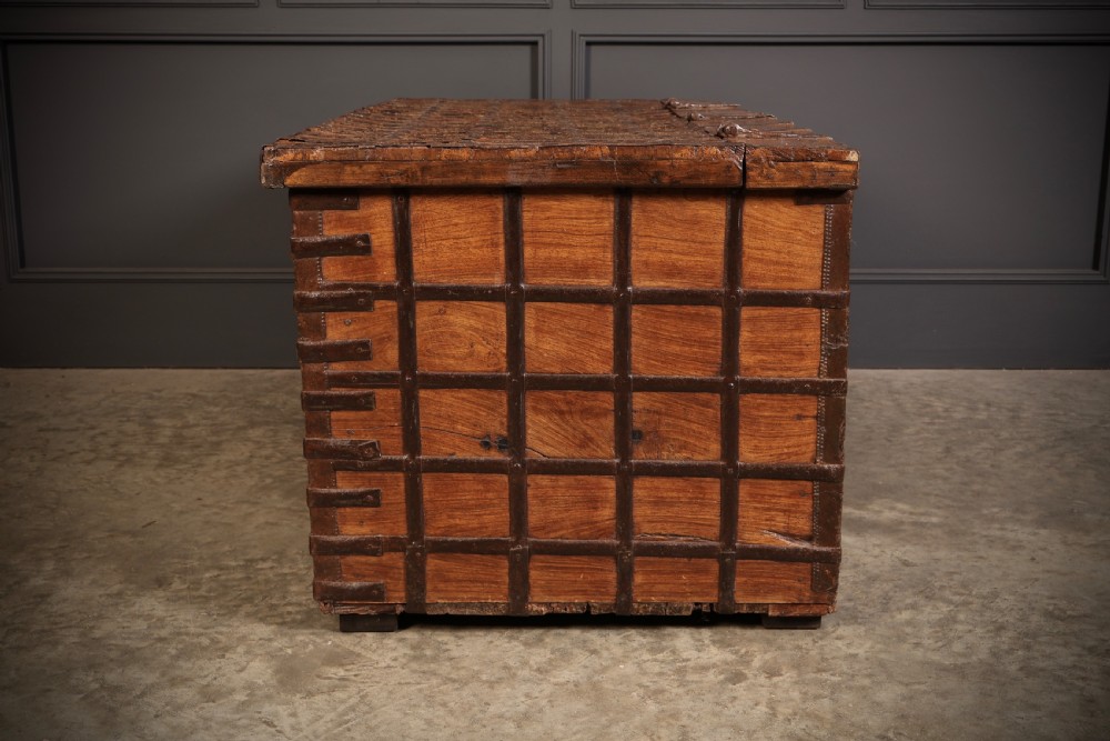 A large rectangular brown hardwood trunk reinforced with a grid of iron straps and featuring heavy iron latches on the front. View XII