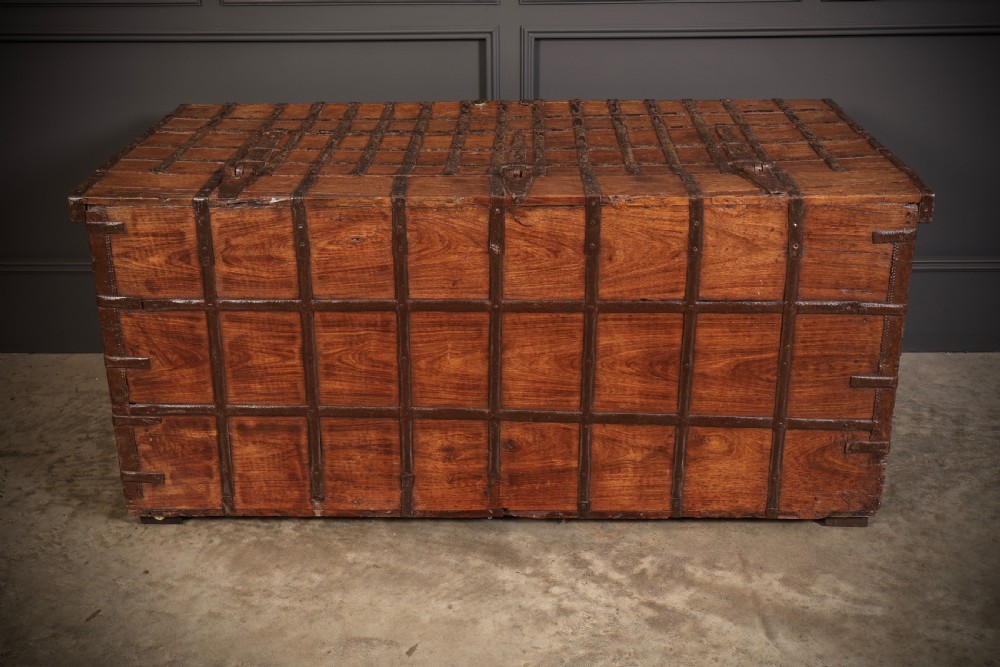 A large rectangular brown hardwood trunk reinforced with a grid of iron straps and featuring heavy iron latches on the front. View XIII