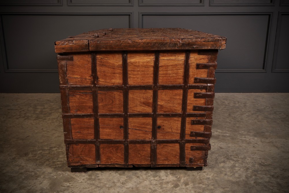 A large rectangular brown hardwood trunk reinforced with a grid of iron straps and featuring heavy iron latches on the front. View XIV