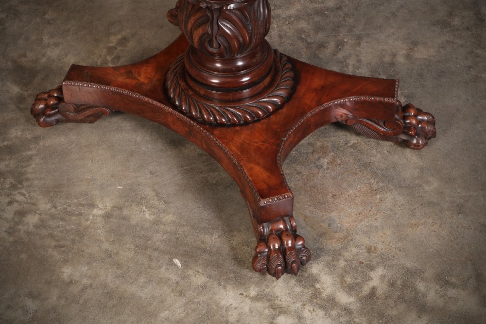 A Regency mahogany card table featuring a fold-over rectangular top, reeded apron, carved central pedestal, and quadripartite base with paw feet. View VII
