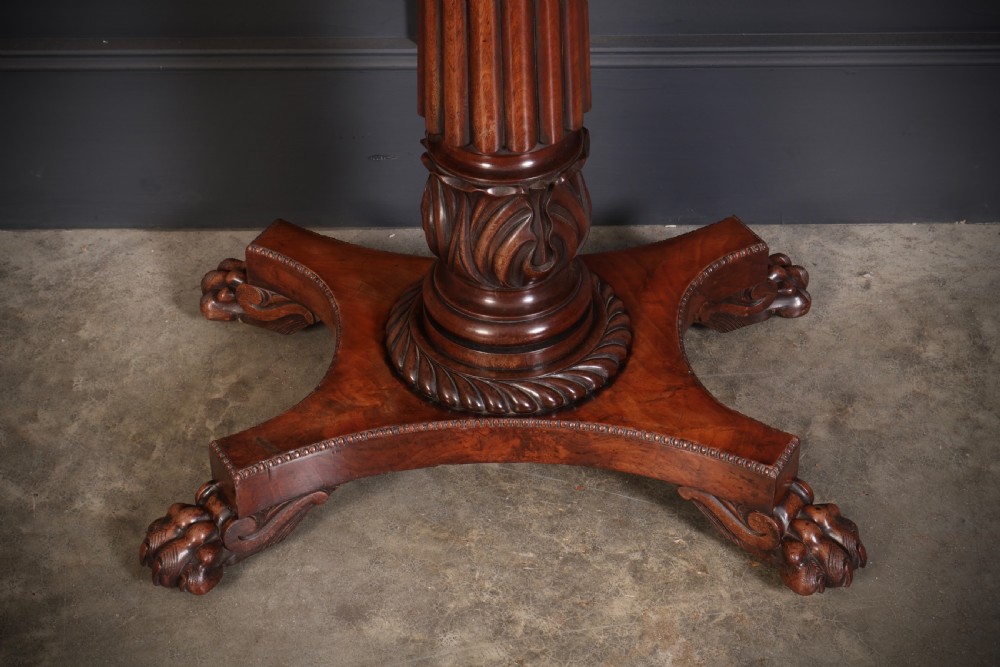 A Regency mahogany card table featuring a fold-over rectangular top, reeded apron, carved central pedestal, and quadripartite base with paw feet. View VIII
