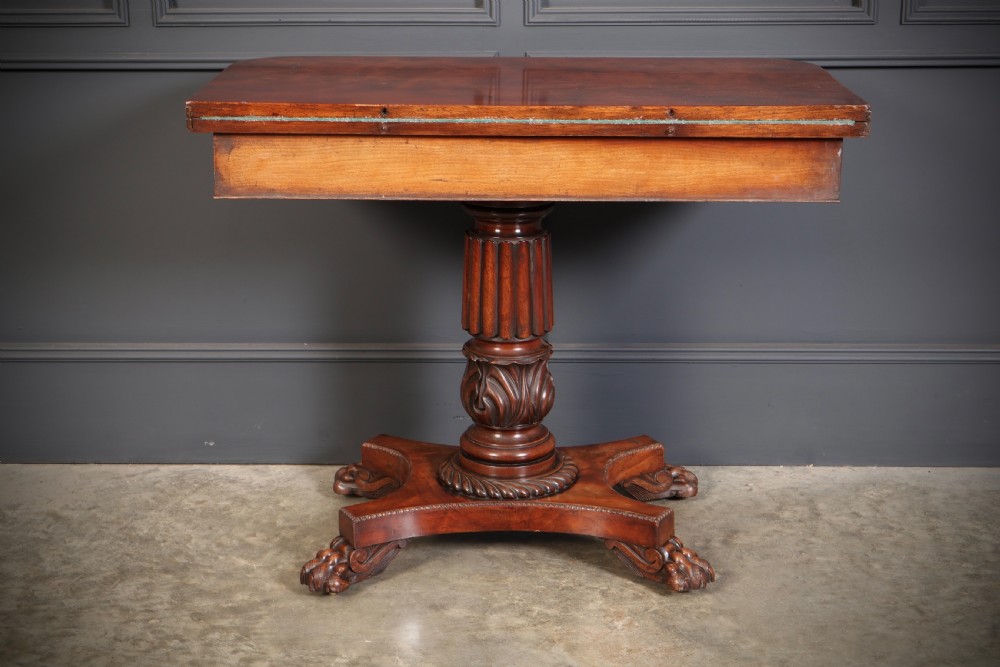 A Regency mahogany card table featuring a fold-over rectangular top, reeded apron, carved central pedestal, and quadripartite base with paw feet. View XIV