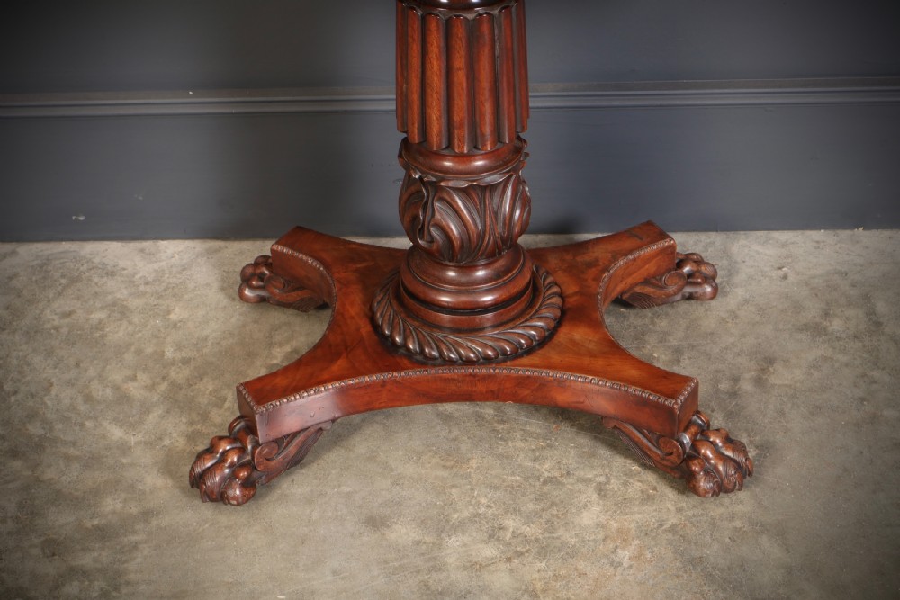 A Regency mahogany card table featuring a fold-over rectangular top, reeded apron, carved central pedestal, and quadripartite base with paw feet. View XV