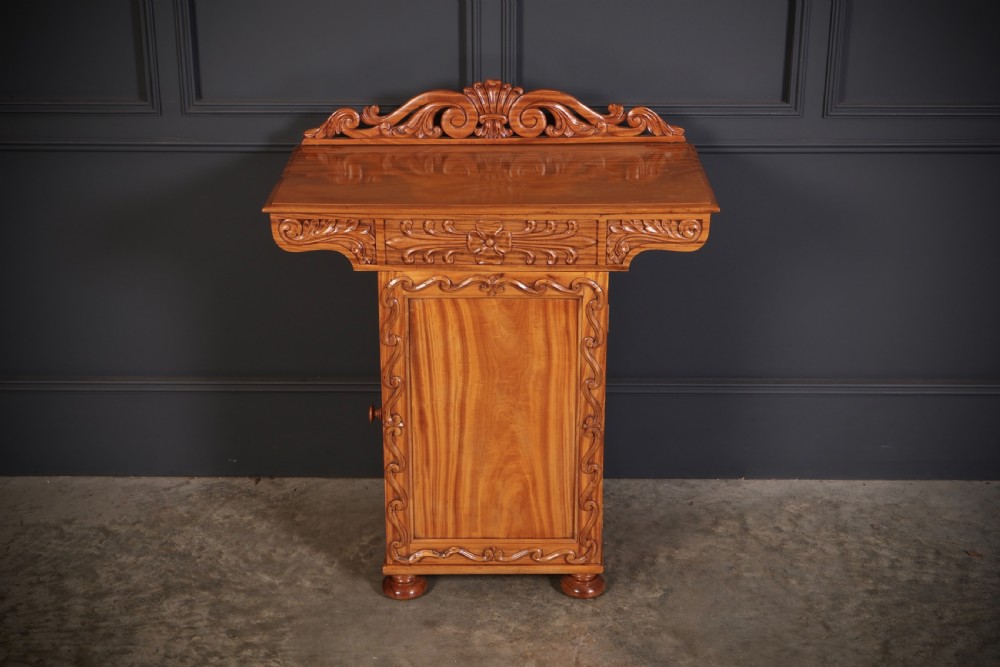 A carved satinwood Anglo-Indian side cabinet featuring a scroll-carved gallery back, panelled door, and turned feet. View III
