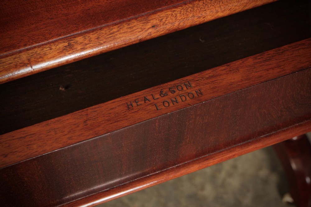 An early Victorian polished mahogany side table featuring turned dual pedestal legs, a central turned stretcher, and curved feet on castors. View XIII