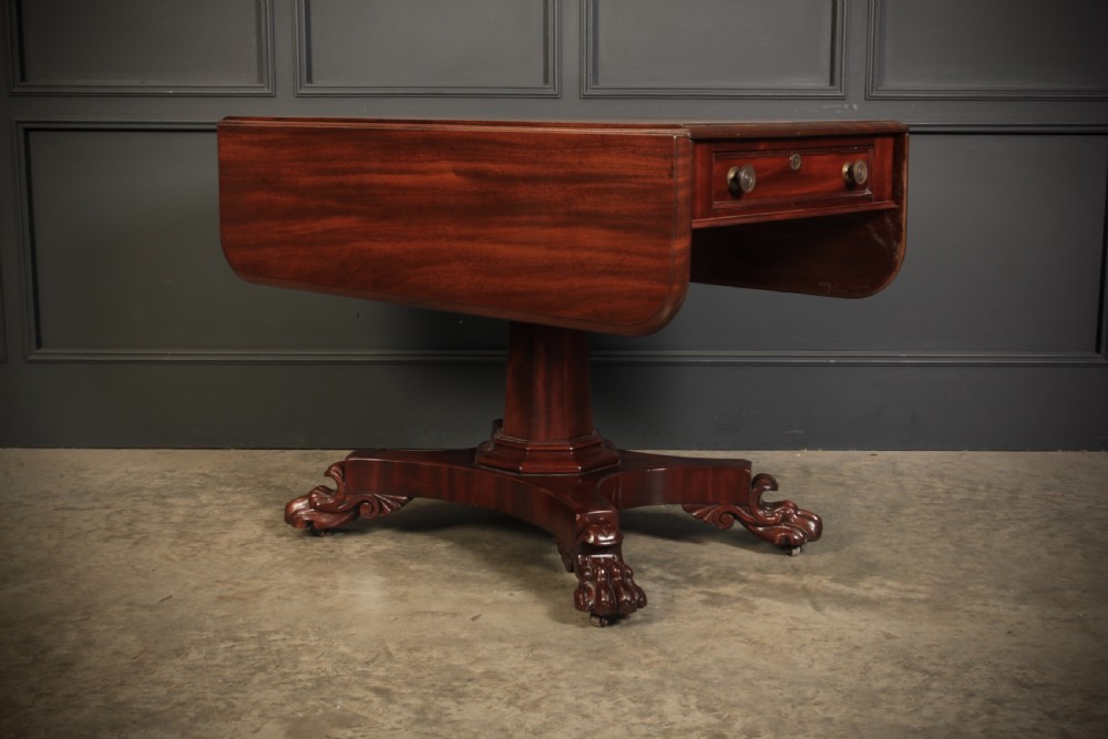 A William IV dark mahogany Pembroke table featuring two drop-down leaves, a single drawer with turned wooden knobs, a central pedestal, and a four-pointed base ending in carved claw feet. View II