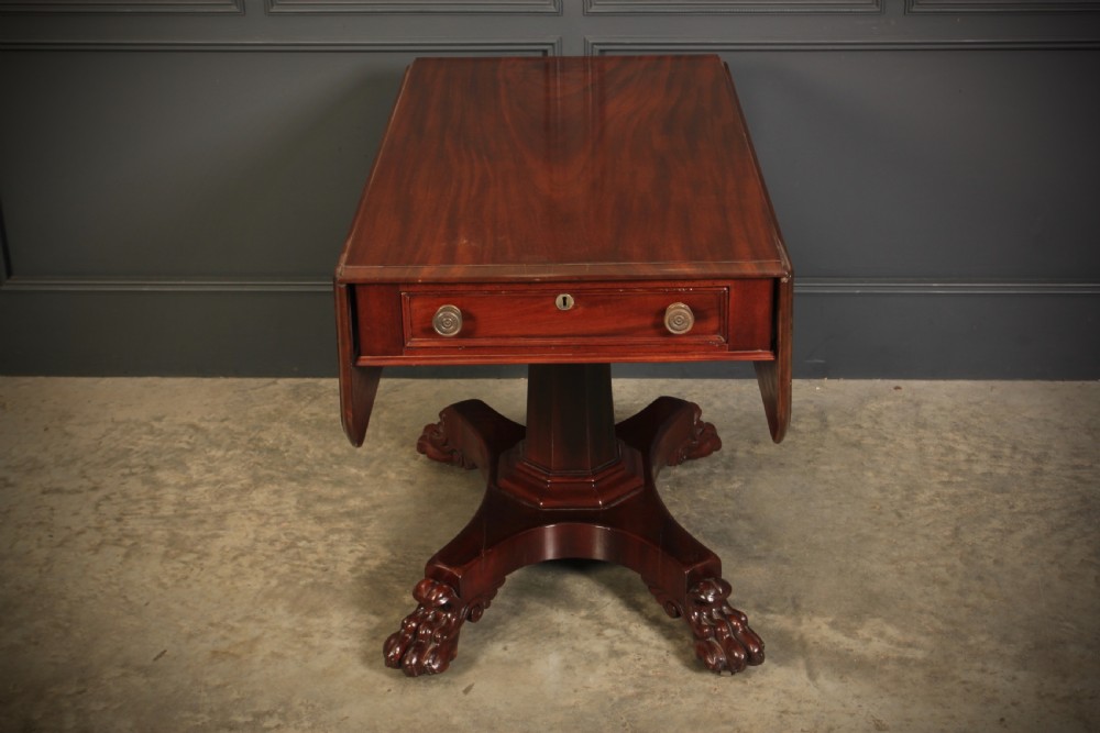 A William IV dark mahogany Pembroke table featuring two drop-down leaves, a single drawer with turned wooden knobs, a central pedestal, and a four-pointed base ending in carved claw feet. View V
