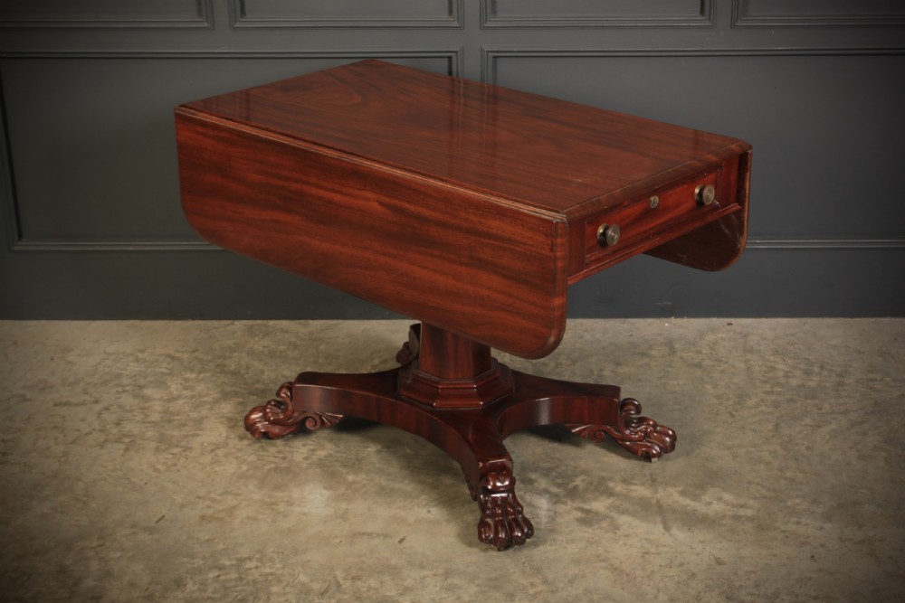 A William IV dark mahogany Pembroke table featuring two drop-down leaves, a single drawer with turned wooden knobs, a central pedestal, and a four-pointed base ending in carved claw feet. View VI