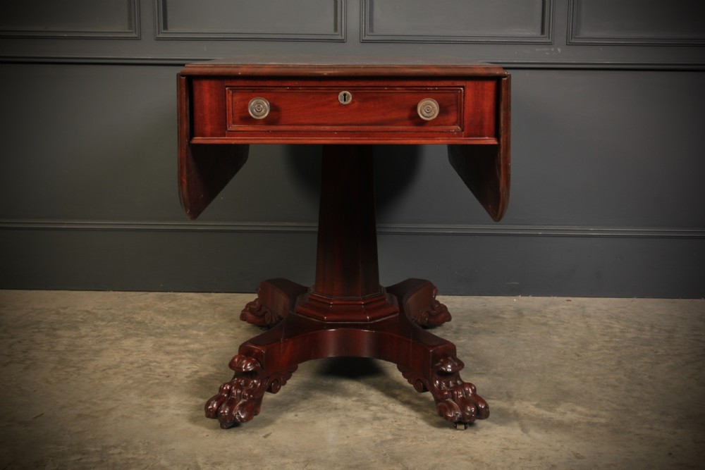 A William IV dark mahogany Pembroke table featuring two drop-down leaves, a single drawer with turned wooden knobs, a central pedestal, and a four-pointed base ending in carved claw feet. View VII