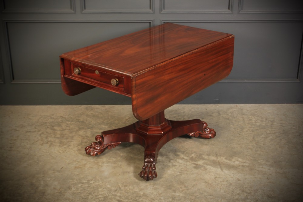 A William IV dark mahogany Pembroke table featuring two drop-down leaves, a single drawer with turned wooden knobs, a central pedestal, and a four-pointed base ending in carved claw feet. View VIII