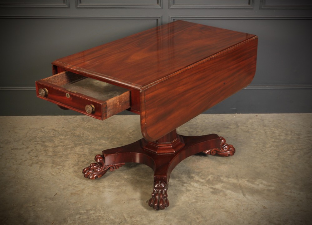 A William IV dark mahogany Pembroke table featuring two drop-down leaves, a single drawer with turned wooden knobs, a central pedestal, and a four-pointed base ending in carved claw feet. View IX