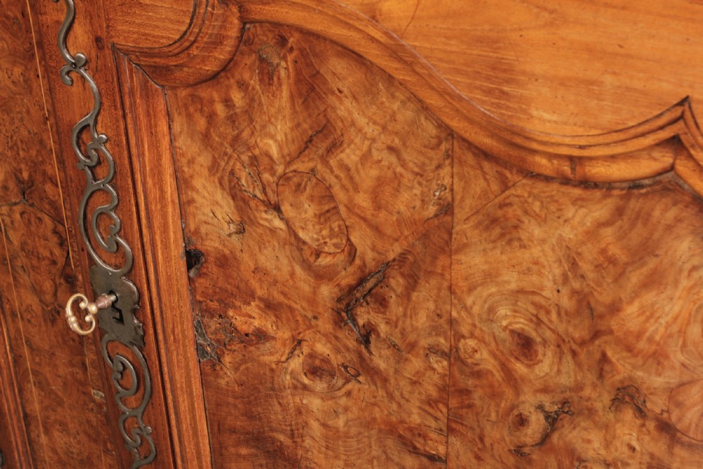 An 18th-century cherrywood and walnut dresser featuring an open tiered plate rack above a base unit with two drawers and two carved cupboard doors. View IV