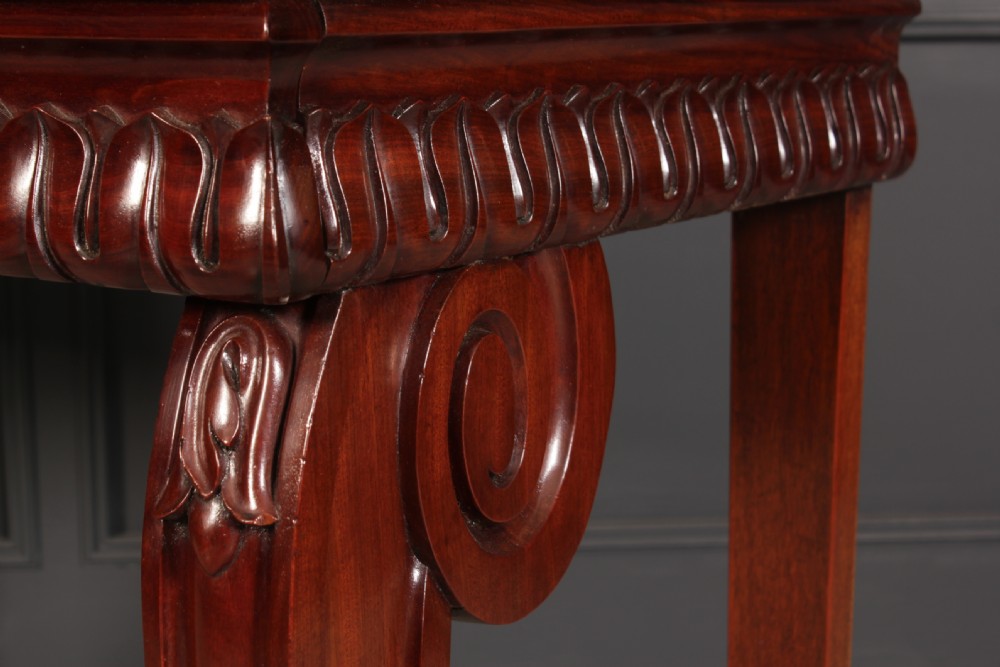 A William IV mahogany console table featuring a raised gallery back, gadrooned edge detailing, and bold S-scroll front legs on brass castors. View XIV