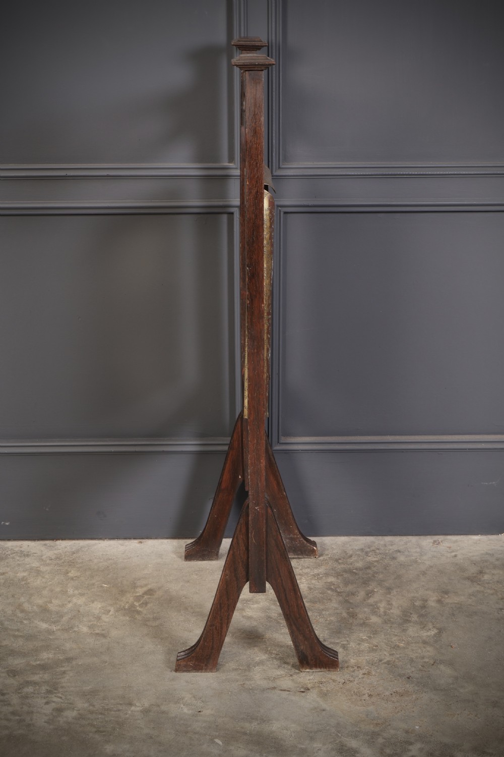 A freestanding dark oak frame housing a suspended rectangular hammered brass dinner gong complete with a wooden striker. View VIII