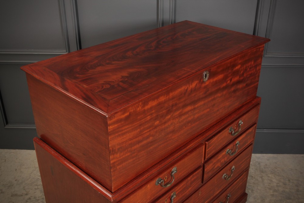 A Georgian mahogany mule chest featuring a top hinged lid above four drawers with brass handles. View V