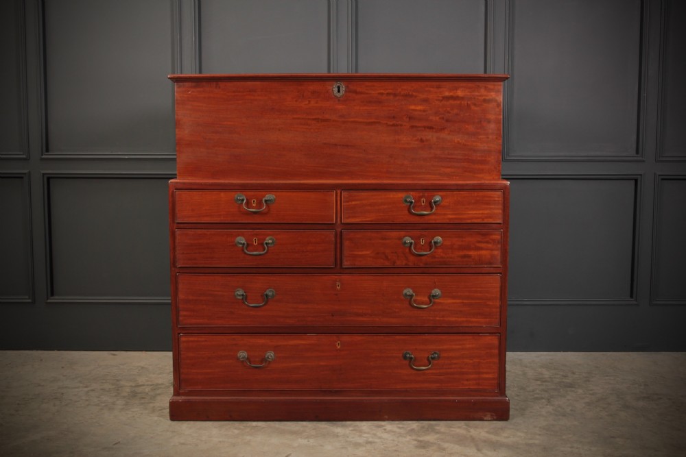 A Georgian mahogany mule chest featuring a top hinged lid above four drawers with brass handles.