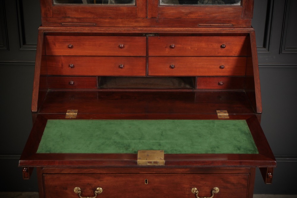 A George III mahogany bureau bookcase featuring two glazed doors on the upper section above a slant-front bureau and four graduated drawers with brass handles. View III