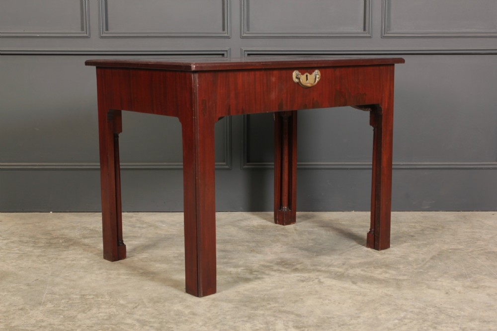 A Georgian mahogany architects table featuring a sliding front drawer with an inlaid leather writing top and square support legs. View II