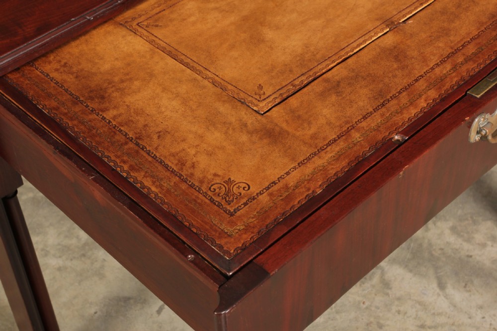 A Georgian mahogany architects table featuring a sliding front drawer with an inlaid leather writing top and square support legs. View III