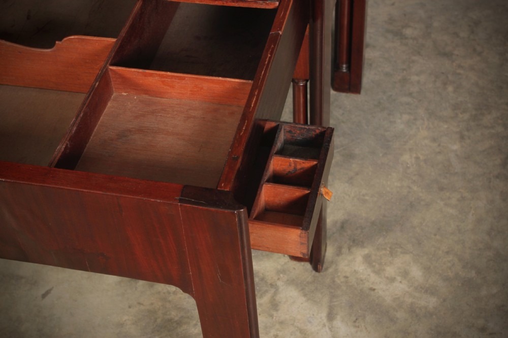 A Georgian mahogany architects table featuring a sliding front drawer with an inlaid leather writing top and square support legs. View IX