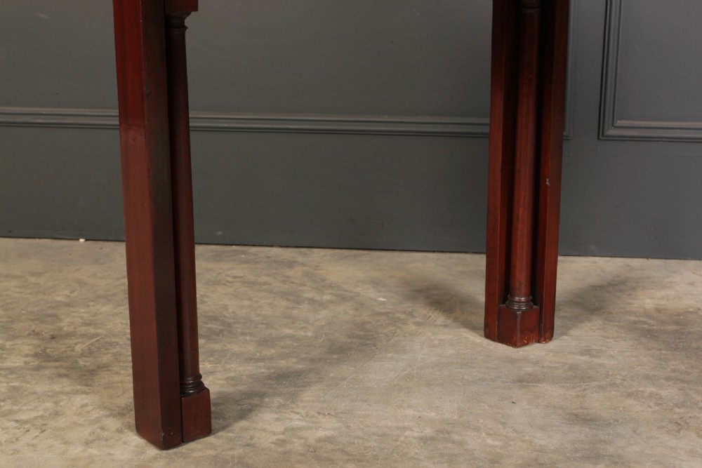 A Georgian mahogany architects table featuring a sliding front drawer with an inlaid leather writing top and square support legs. View XII