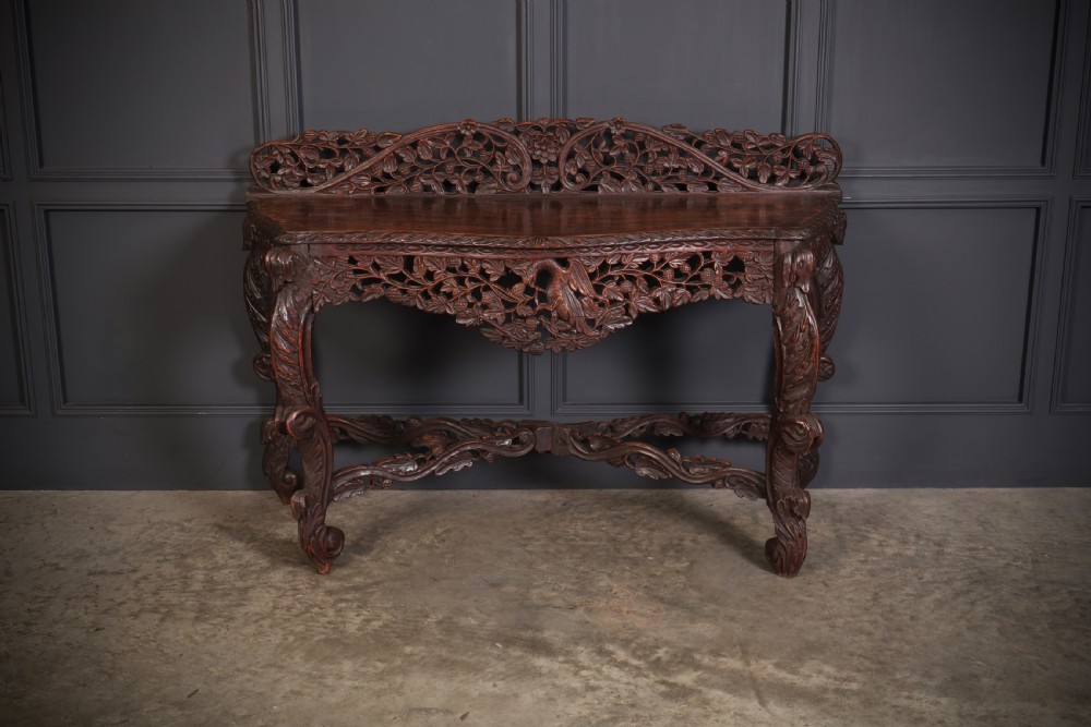 A 19th-century dark hardwood console table featuring pierced foliate carving along the apron, gallery back, and curved legs. View III