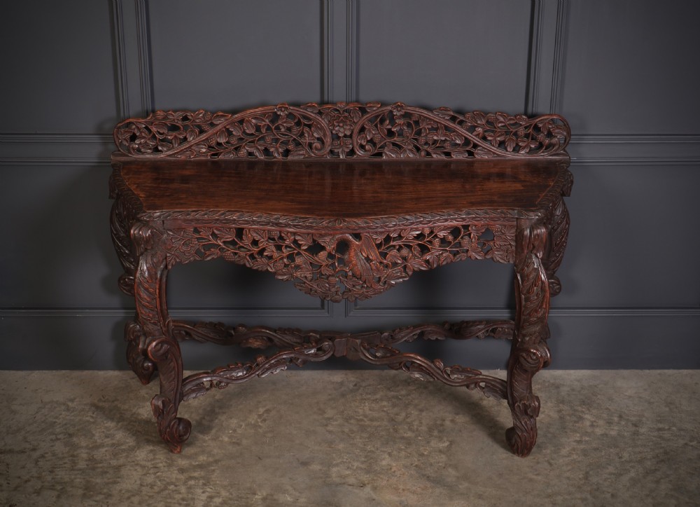 A 19th-century dark hardwood console table featuring pierced foliate carving along the apron, gallery back, and curved legs. View II