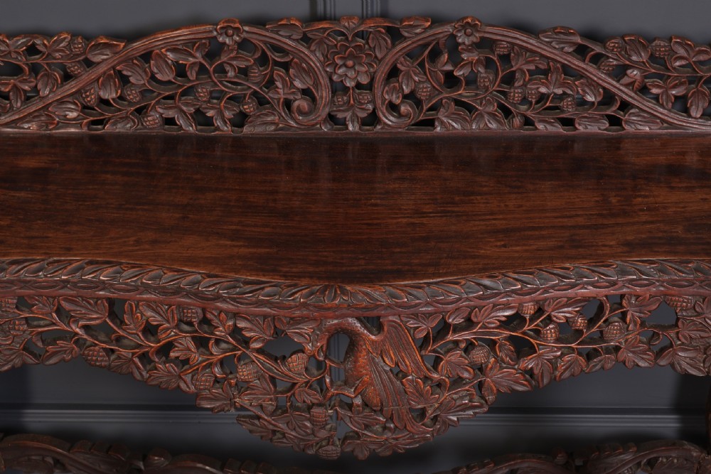A 19th-century dark hardwood console table featuring pierced foliate carving along the apron, gallery back, and curved legs. View VII
