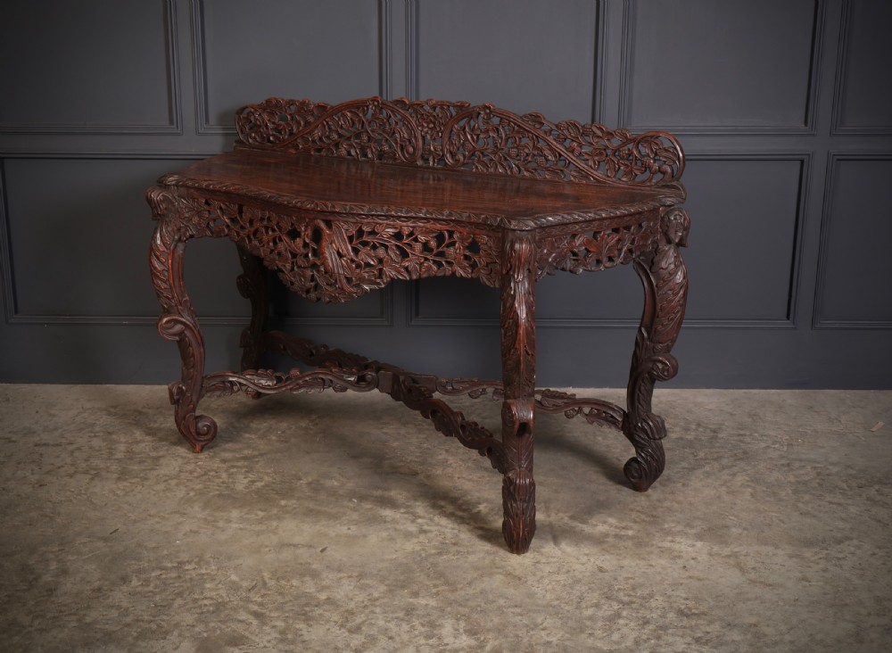 A 19th-century dark hardwood console table featuring pierced foliate carving along the apron, gallery back, and curved legs. View IX