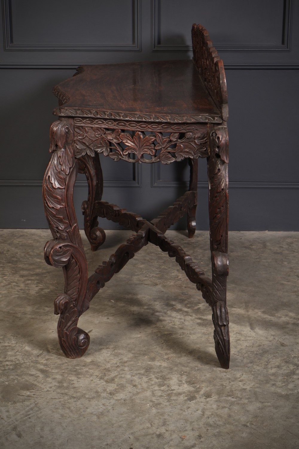 A 19th-century dark hardwood console table featuring pierced foliate carving along the apron, gallery back, and curved legs. View XI