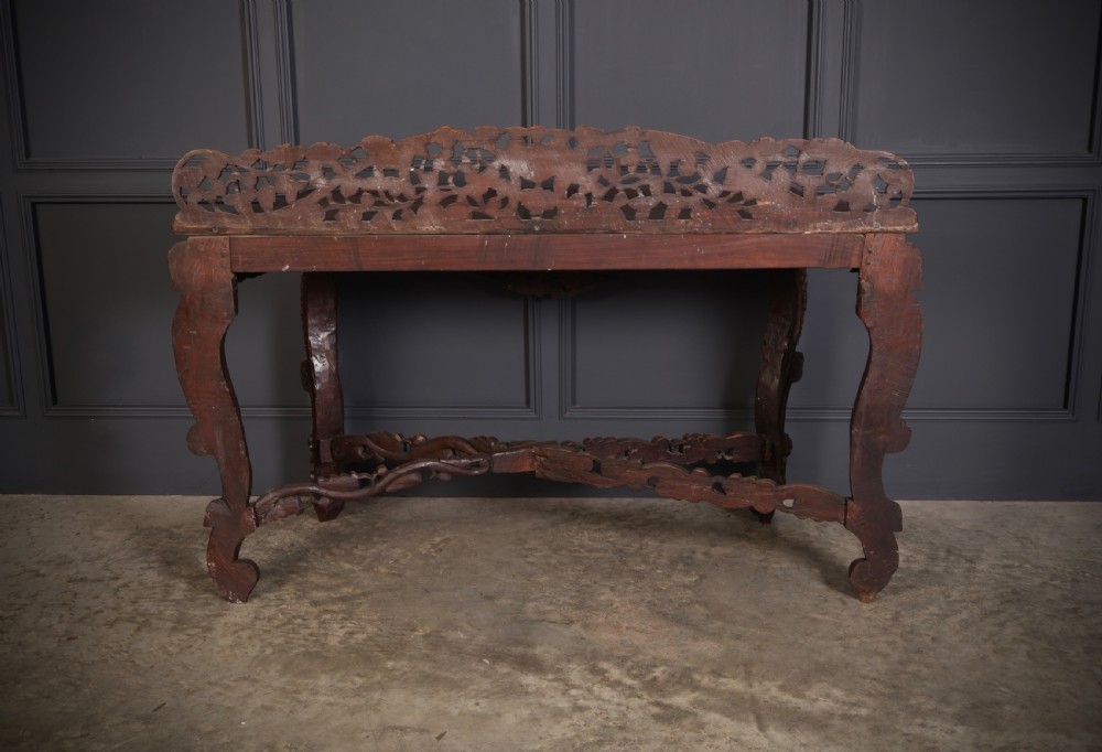 A 19th-century dark hardwood console table featuring pierced foliate carving along the apron, gallery back, and curved legs. View XII
