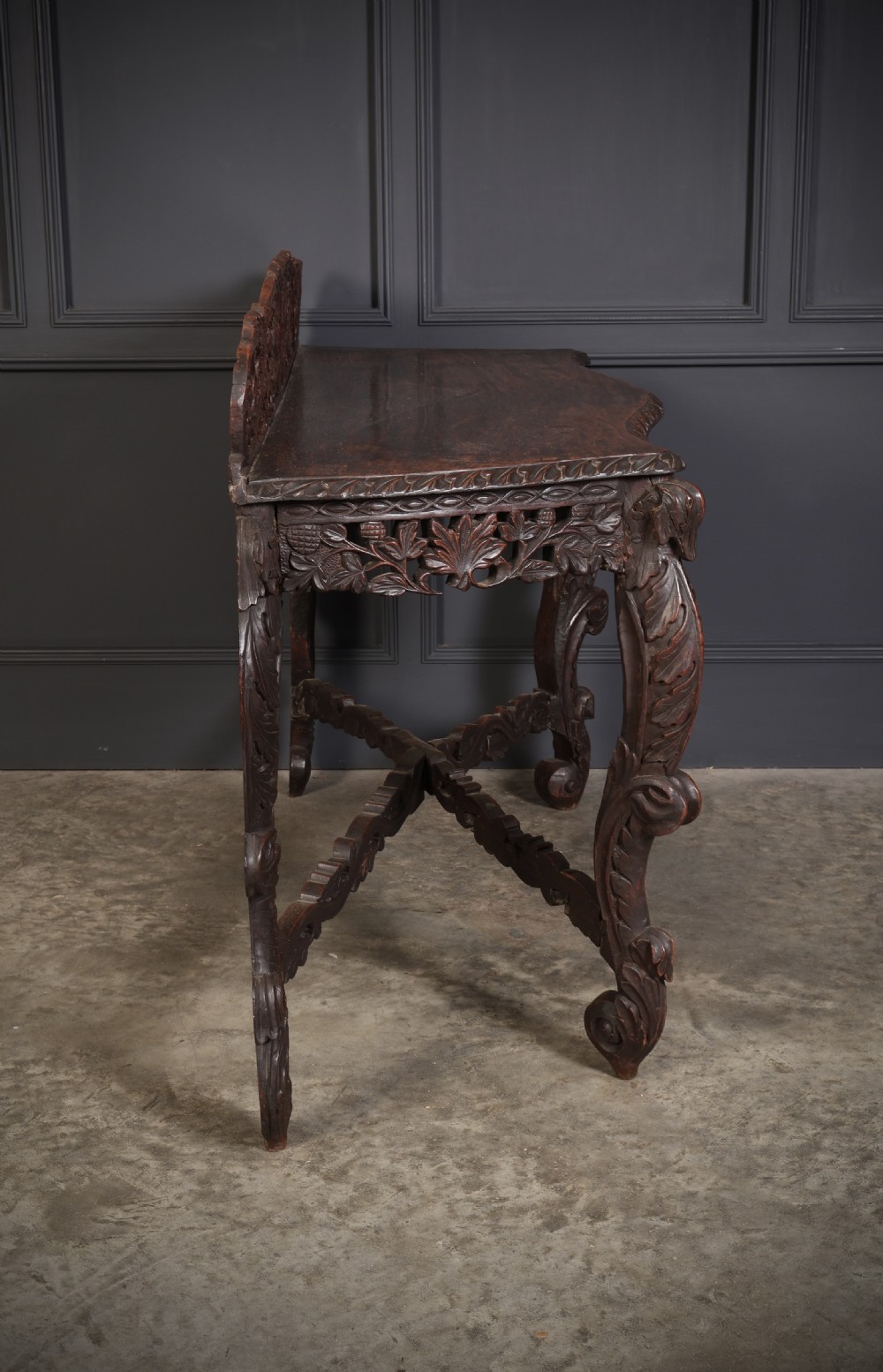 A 19th-century dark hardwood console table featuring pierced foliate carving along the apron, gallery back, and curved legs. View XIII