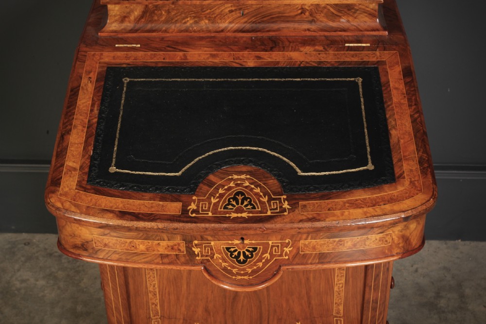 A 19th-century Victorian walnut Davenport desk featuring a sloped leather writing surface, side drawers with wooden knobs, and floral marquetry inlays. View III