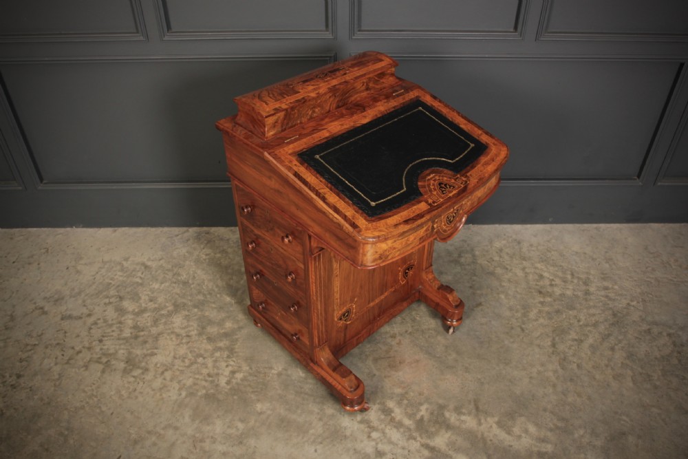 A 19th-century Victorian walnut Davenport desk featuring a sloped leather writing surface, side drawers with wooden knobs, and floral marquetry inlays. View XIII