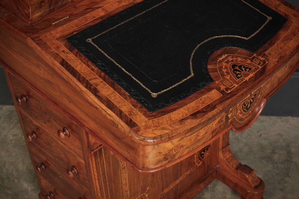 A 19th-century Victorian walnut Davenport desk featuring a sloped leather writing surface, side drawers with wooden knobs, and floral marquetry inlays. View XIV