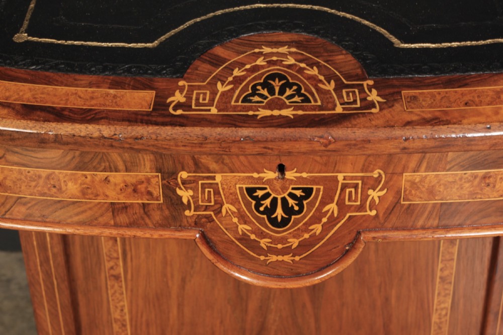 A 19th-century Victorian walnut Davenport desk featuring a sloped leather writing surface, side drawers with wooden knobs, and floral marquetry inlays. View XV