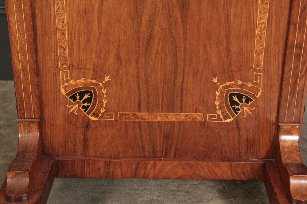 A 19th-century Victorian walnut Davenport desk featuring a sloped leather writing surface, side drawers with wooden knobs, and floral marquetry inlays. View XVI