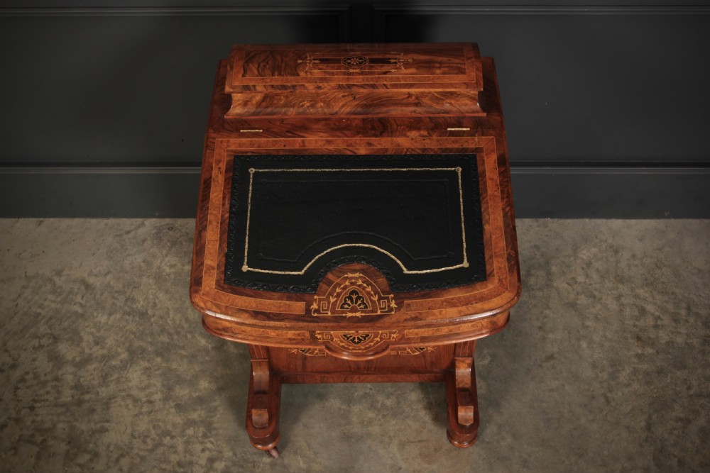 A 19th-century Victorian walnut Davenport desk featuring a sloped leather writing surface, side drawers with wooden knobs, and floral marquetry inlays. View XXII