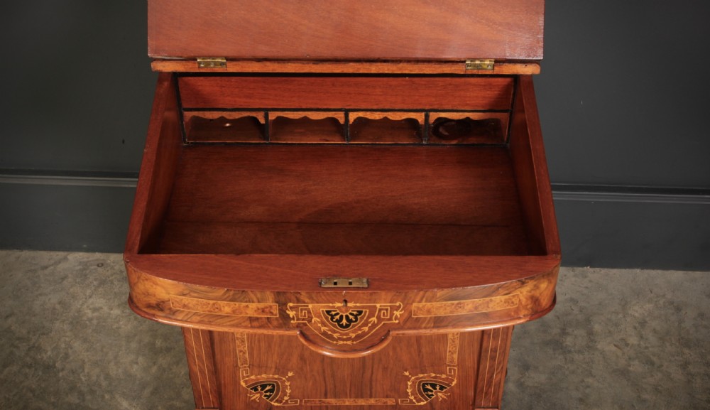 A 19th-century Victorian walnut Davenport desk featuring a sloped leather writing surface, side drawers with wooden knobs, and floral marquetry inlays. View XXIII
