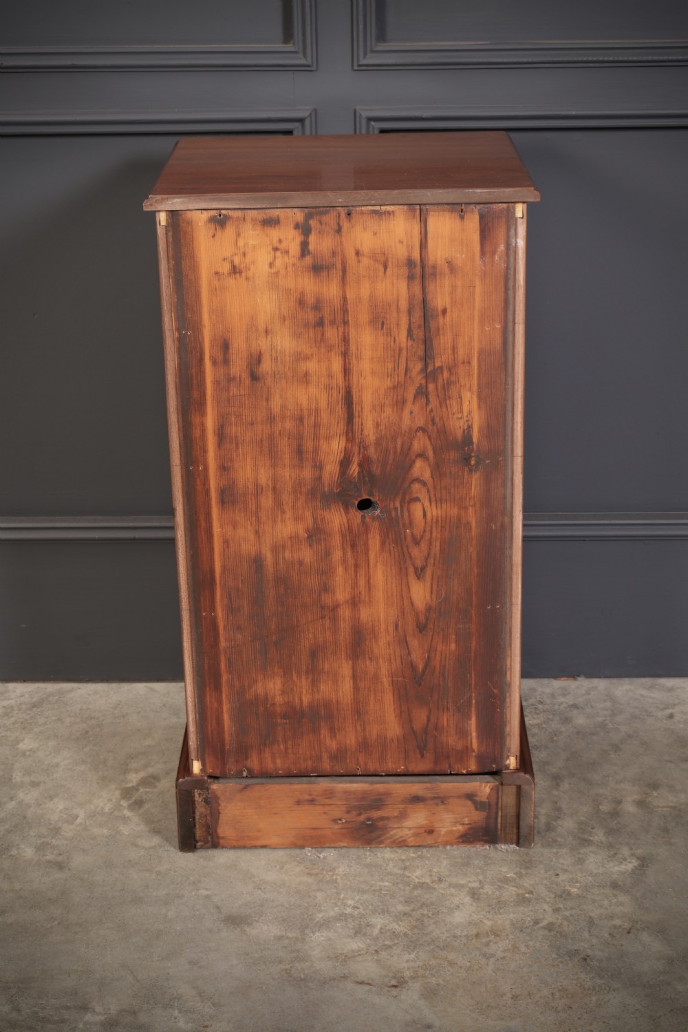 A pair of late Victorian walnut bedside chests, each featuring four drawers with ornamental brass handles on a plinth base. View XI