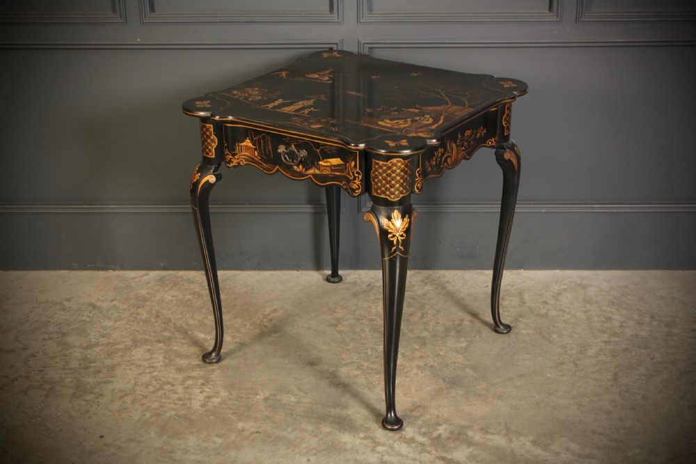 A black lacquered occasional table with gilded Chinoiserie scenes, a scalloped rim, and cabriole legs. View III