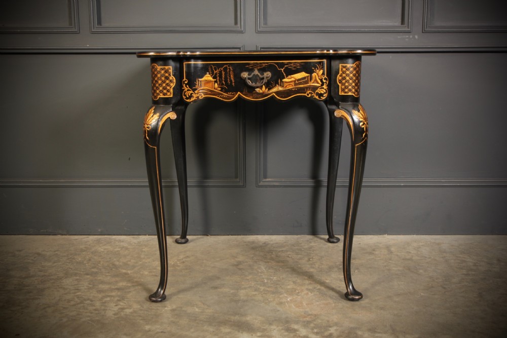 A black lacquered occasional table with gilded Chinoiserie scenes, a scalloped rim, and cabriole legs. View VIII