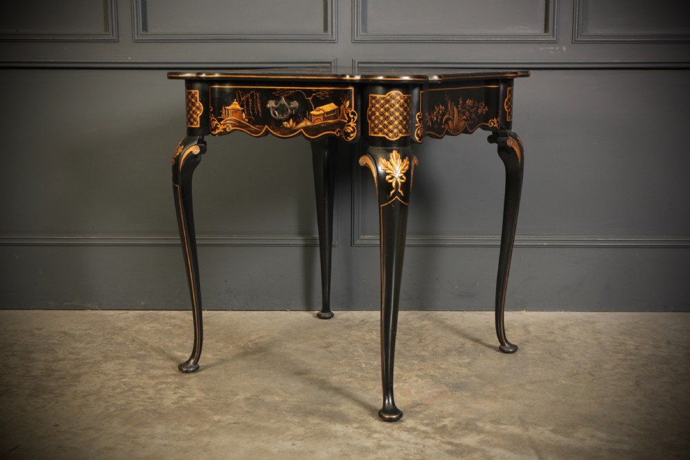 A black lacquered occasional table with gilded Chinoiserie scenes, a scalloped rim, and cabriole legs. View XI