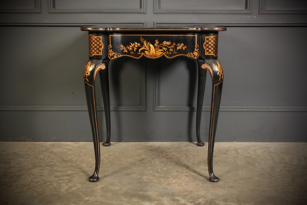 A black lacquered occasional table with gilded Chinoiserie scenes, a scalloped rim, and cabriole legs. View XII