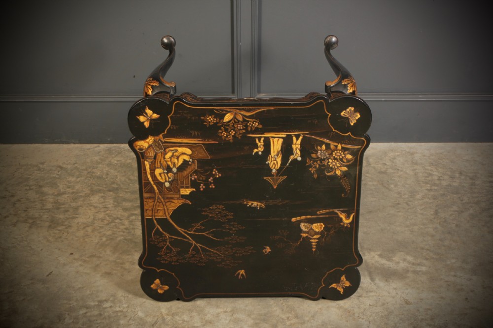 A black lacquered occasional table with gilded Chinoiserie scenes, a scalloped rim, and cabriole legs. View XIV