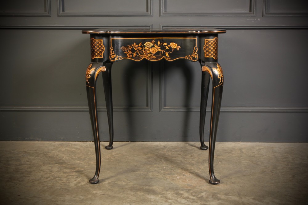 A black lacquered occasional table with gilded Chinoiserie scenes, a scalloped rim, and cabriole legs. View XVI