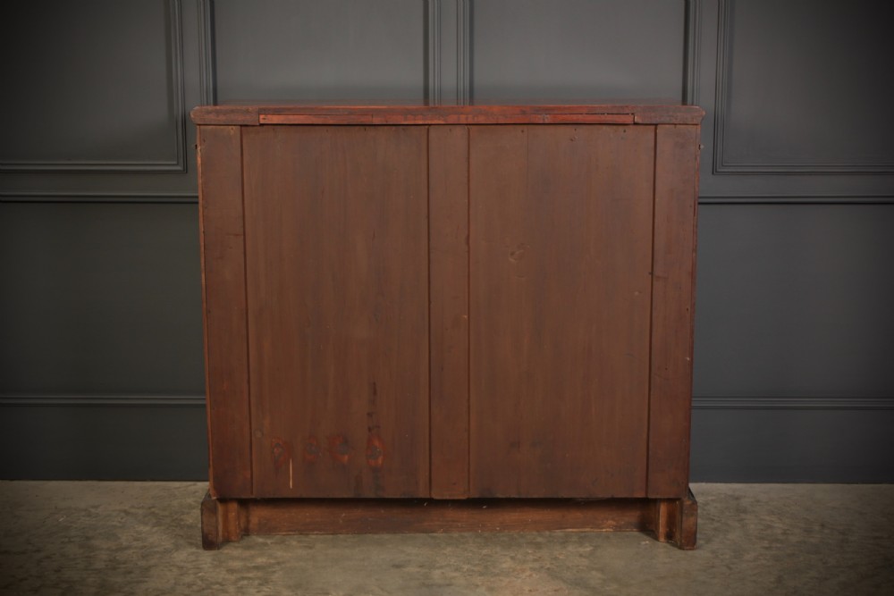 A low Victorian bookcase constructed from figured walnut wood featuring two glazed glass doors, black carved corbels, and internal timber shelves. View XIII