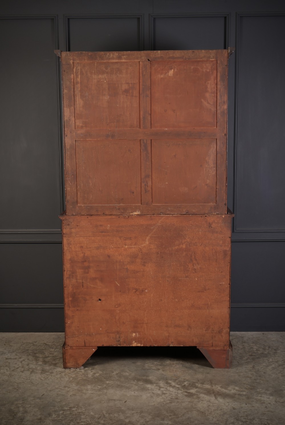 A George III mahogany secretaire cabinet featuring a twin panelled cupboard top over a lower chest of drawers with bracket feet. View IX