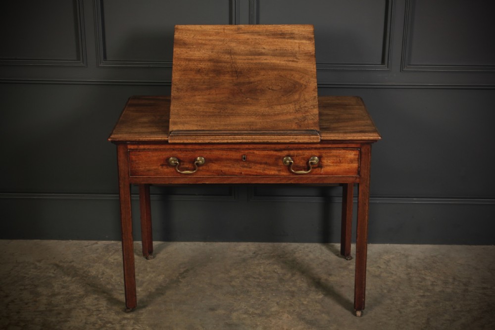 A Georgian mahogany architects table with a hinged adjustable writing slope top, a single drawer with brass swan-neck handles, and straight square legs fitted with brass castors. View XIII